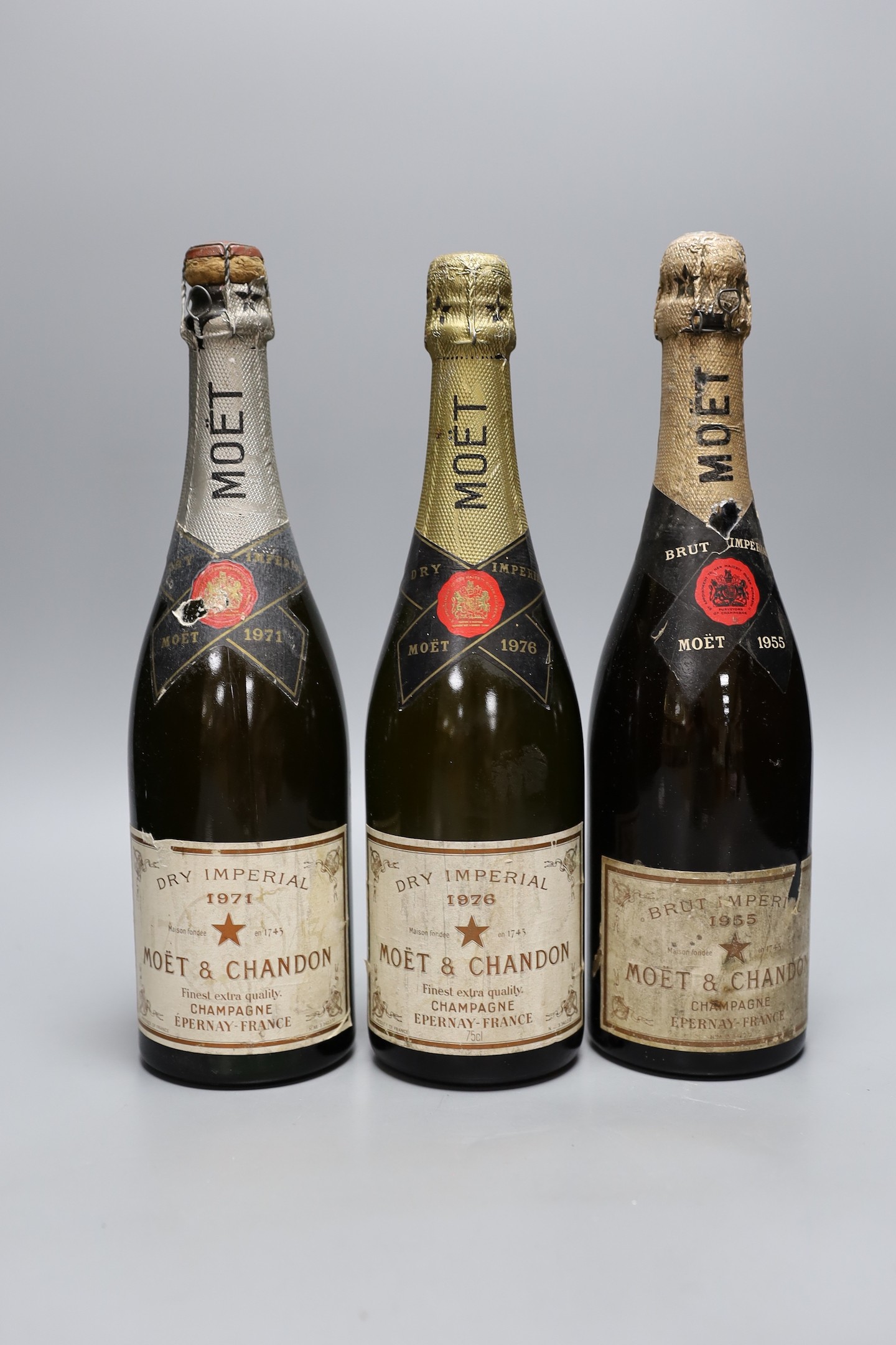 A bottle of 1955 Brut Imperial Moet & Chandon champagne together with two Moët Chandon, Dry Imperial champagnes-1971 and 1976